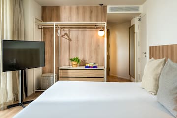 a room with a bed and a tv