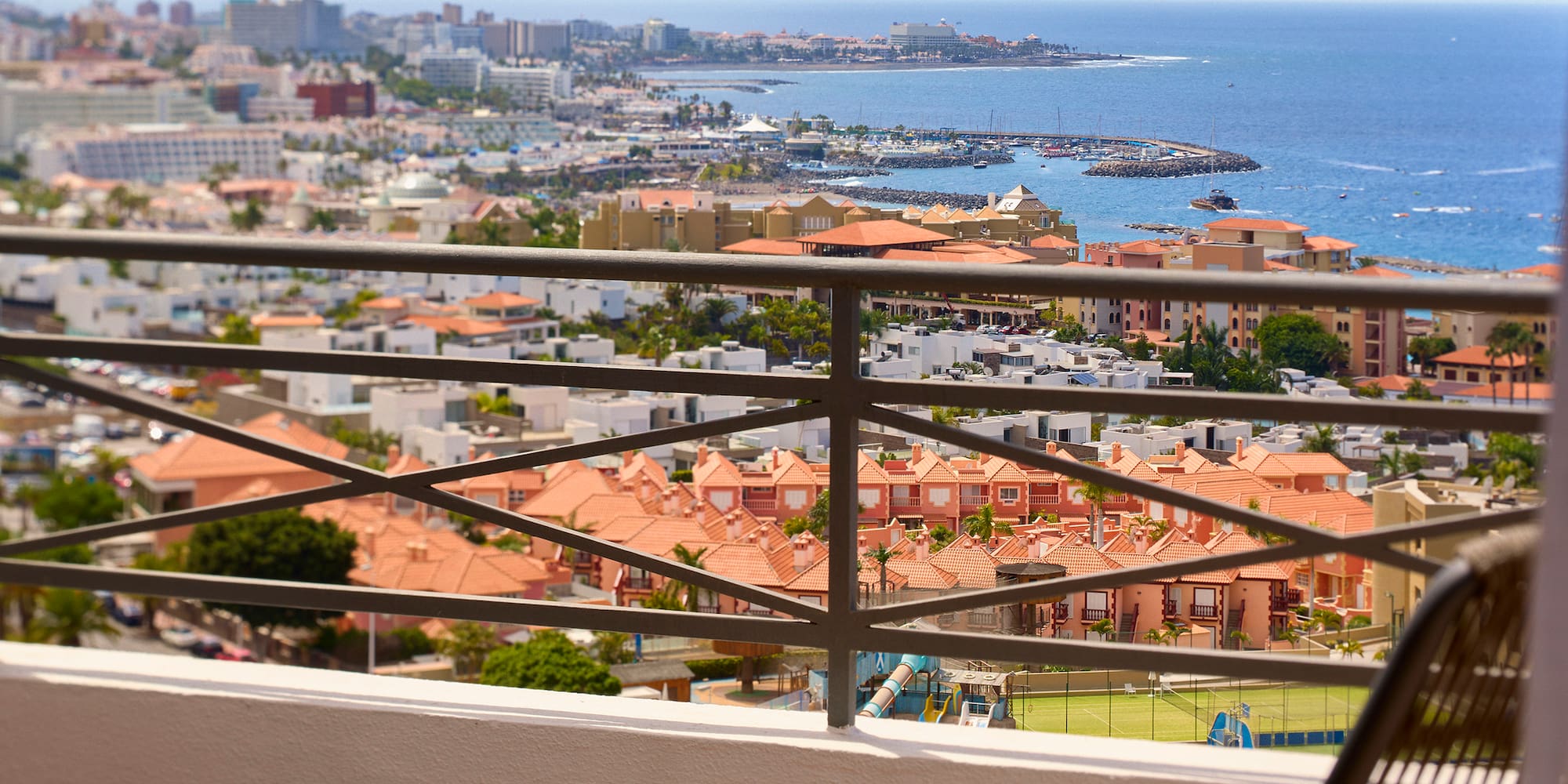 a chair and table with a view of a city and water