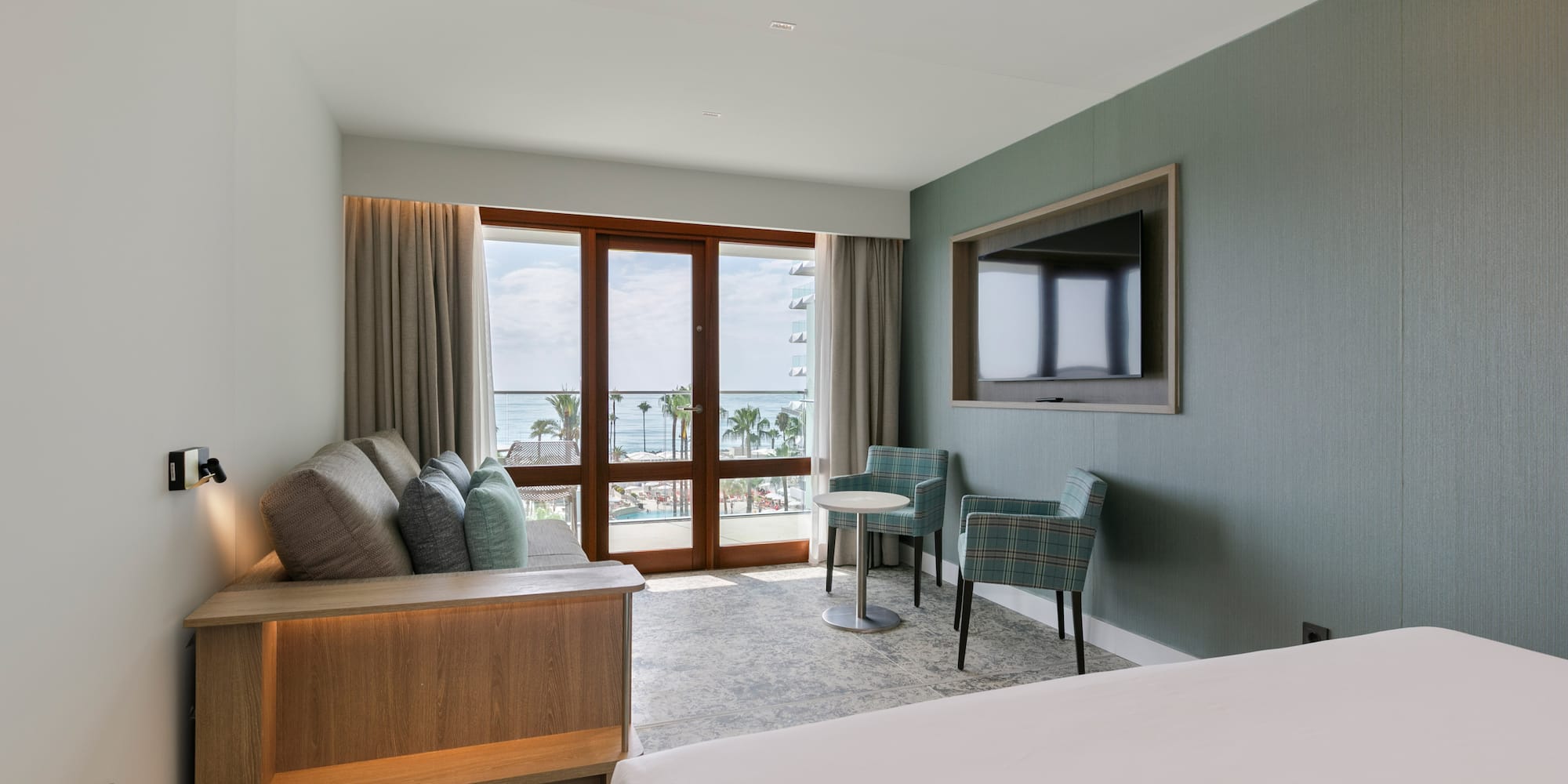 a room with a bed and a television