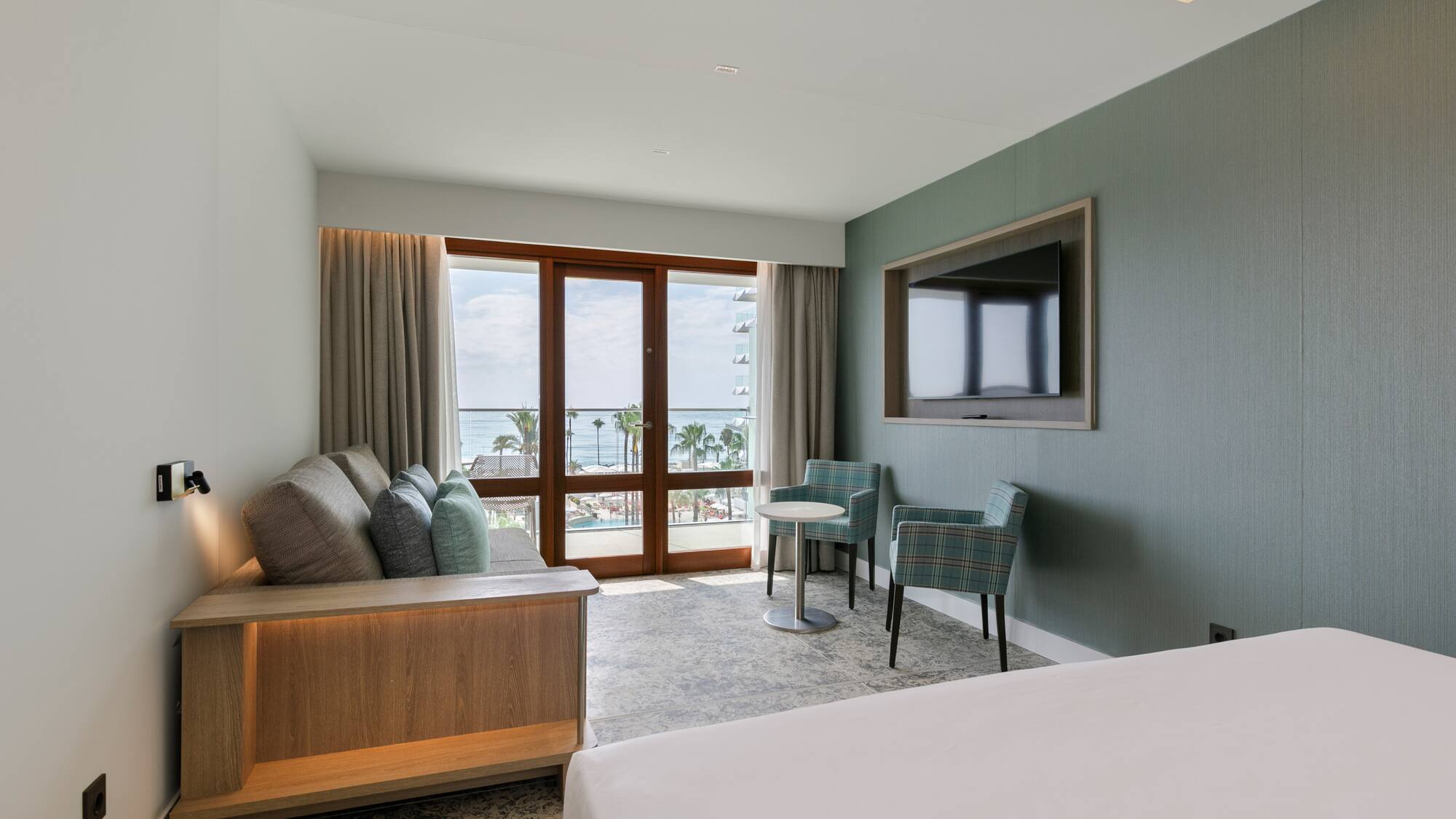 a room with a bed and a television