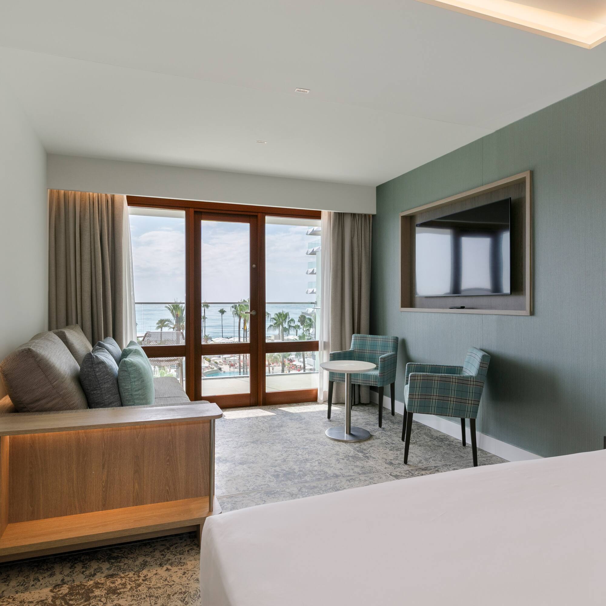 a room with a bed and a television