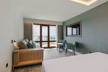 a room with a bed and a television