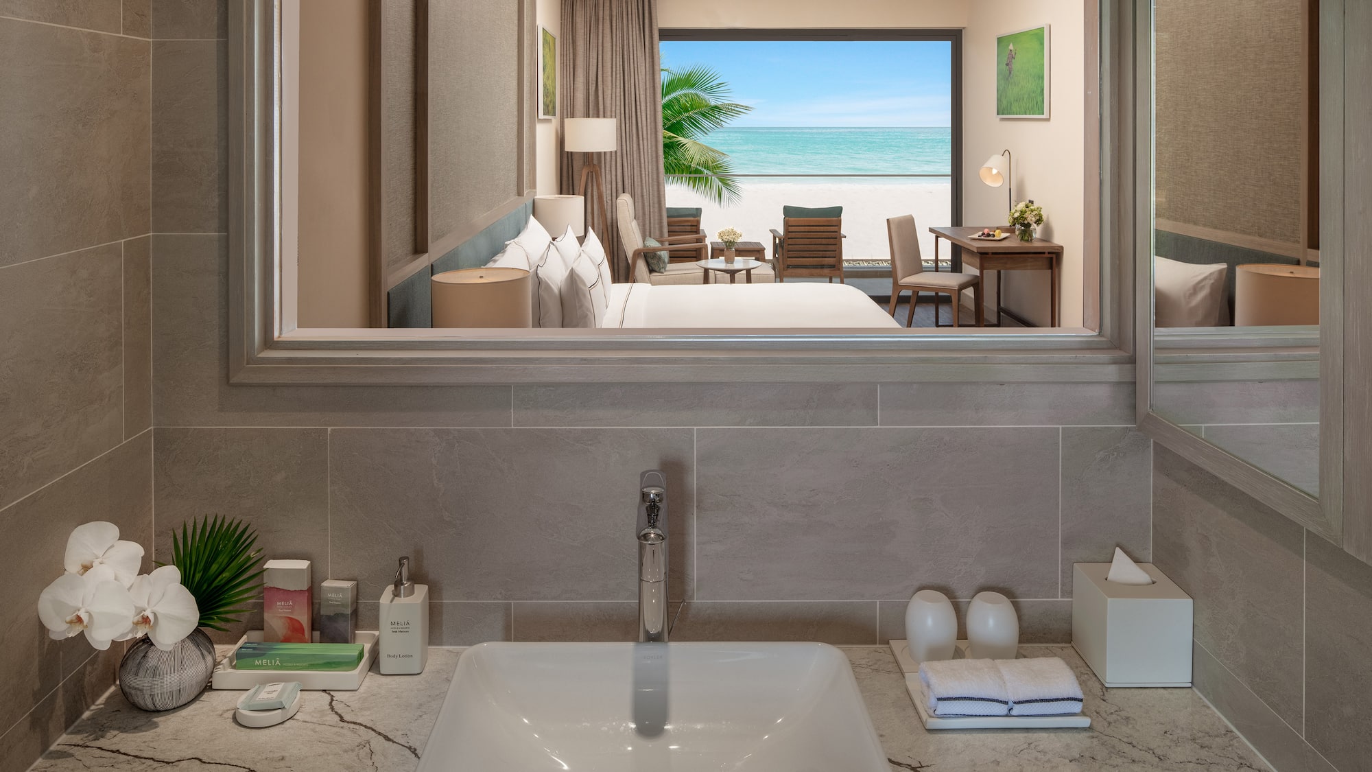 a bathroom with a mirror and a view of the ocean