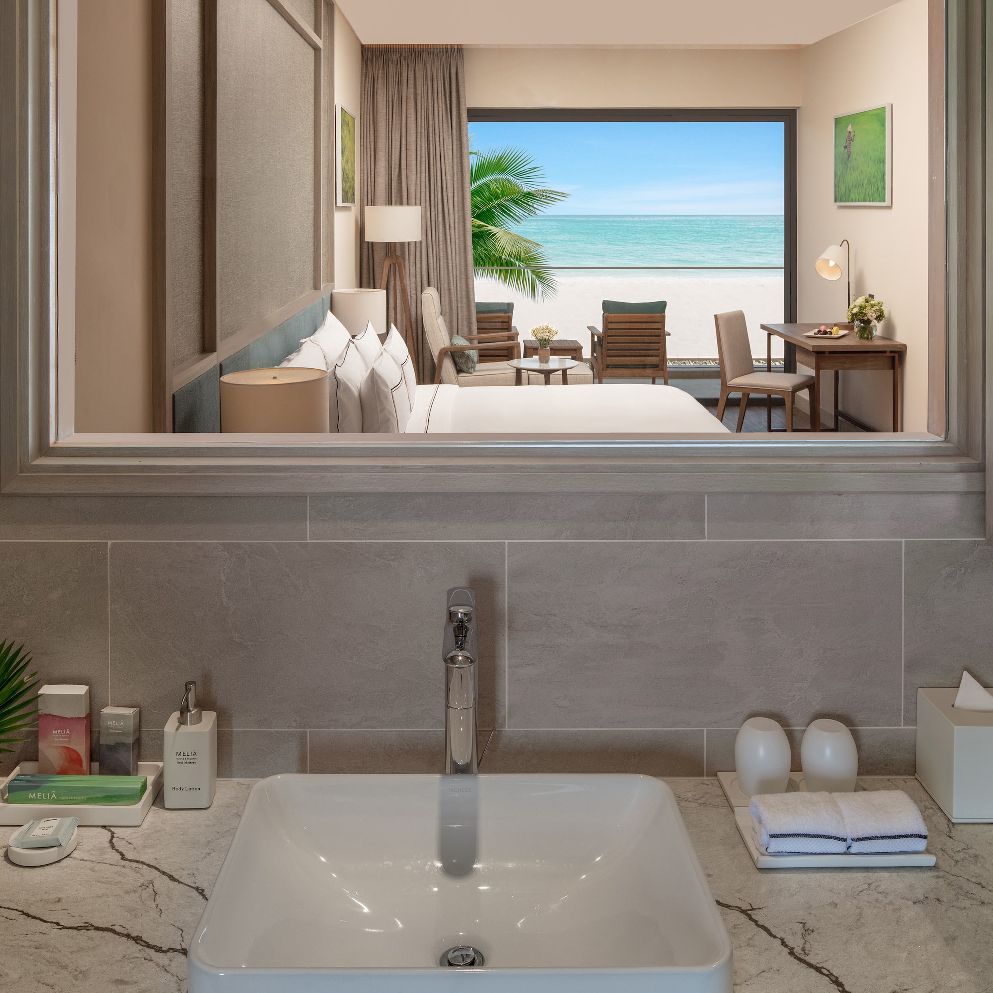 a bathroom with a mirror and a view of the ocean