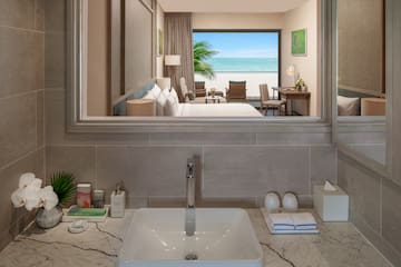 a bathroom with a mirror and a view of the ocean