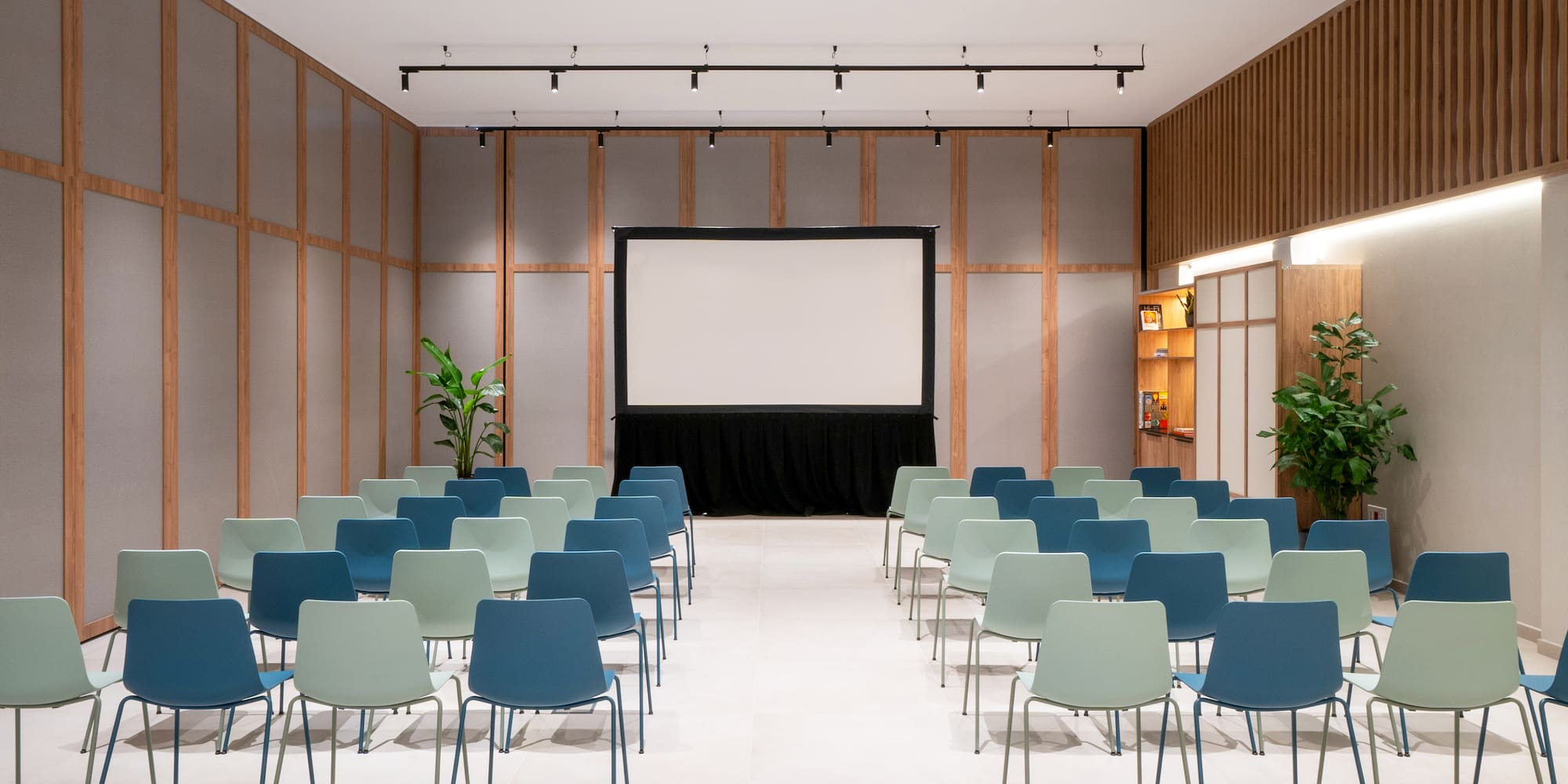 a room with chairs and a screen