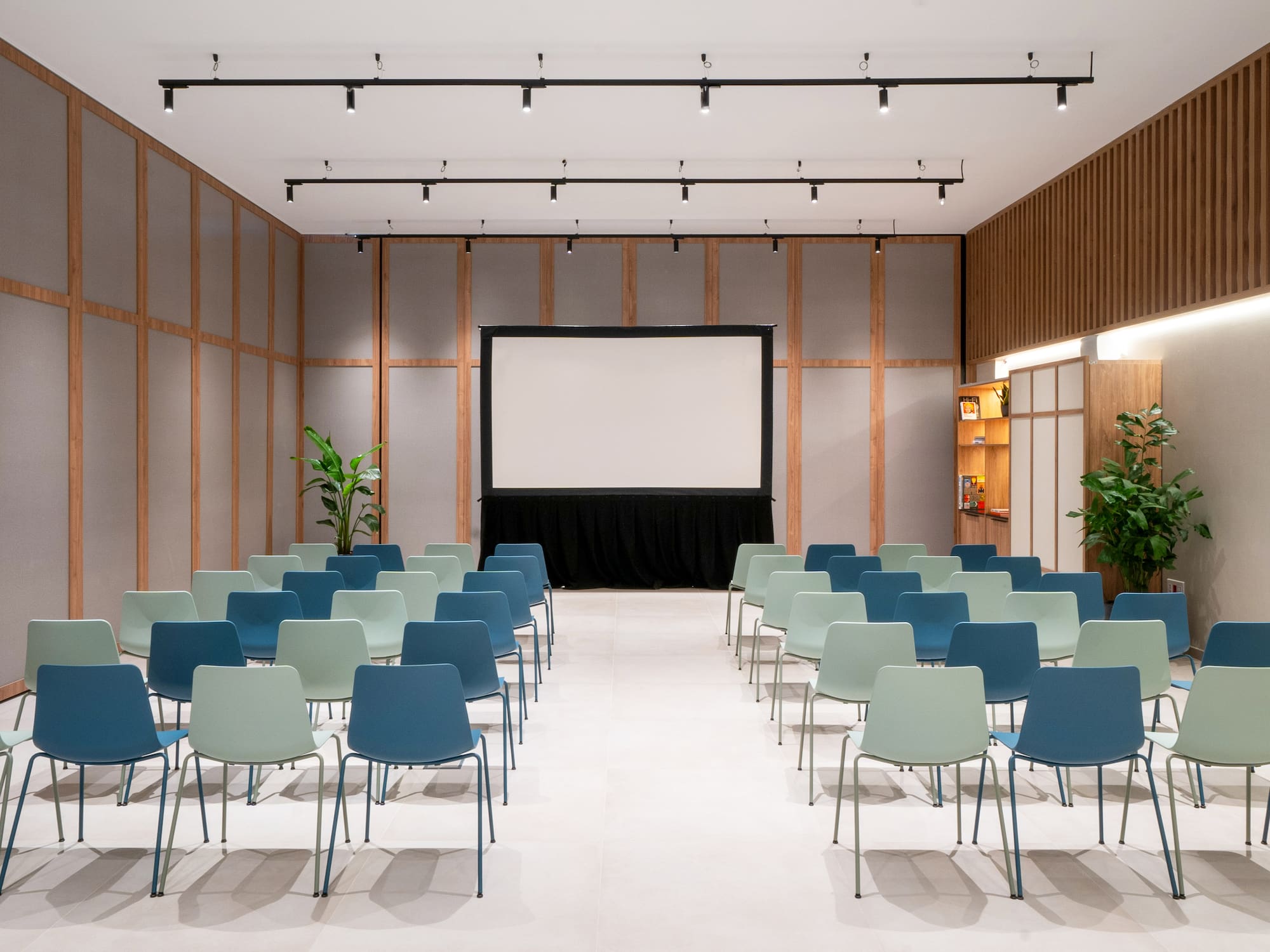a room with chairs and a screen