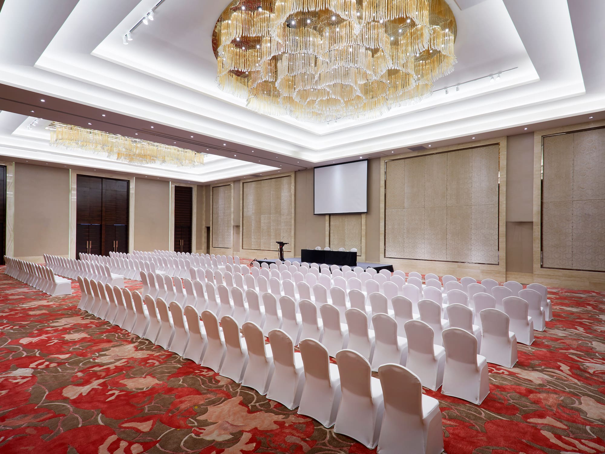 a room with chairs and chandeliers