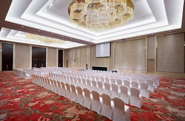 a room with chairs and chandeliers