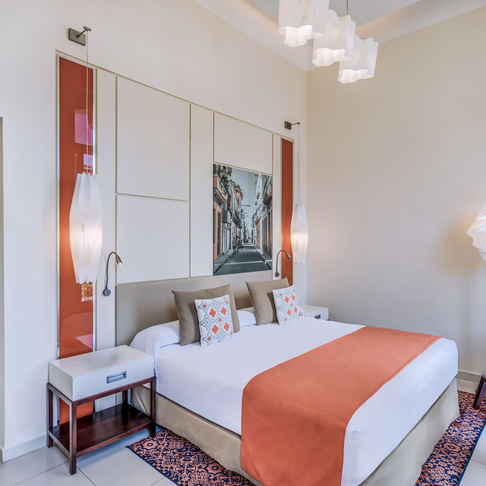 a bedroom with a bed and lamps