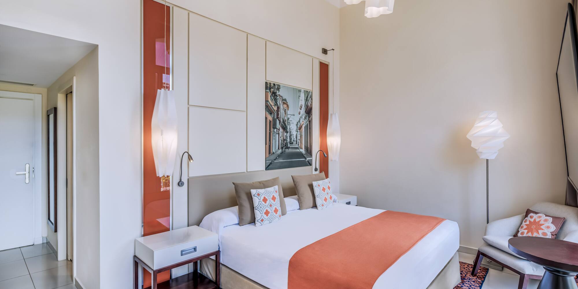 a bedroom with a bed and lamps