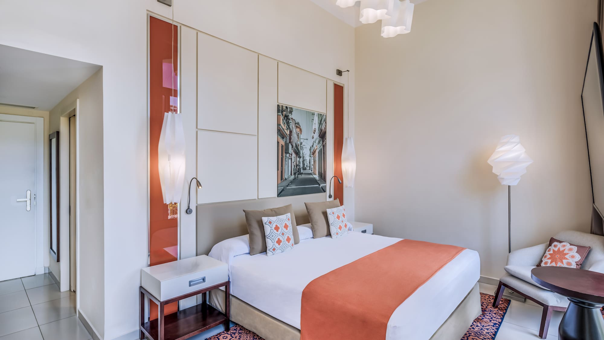 a bedroom with a bed and lamps