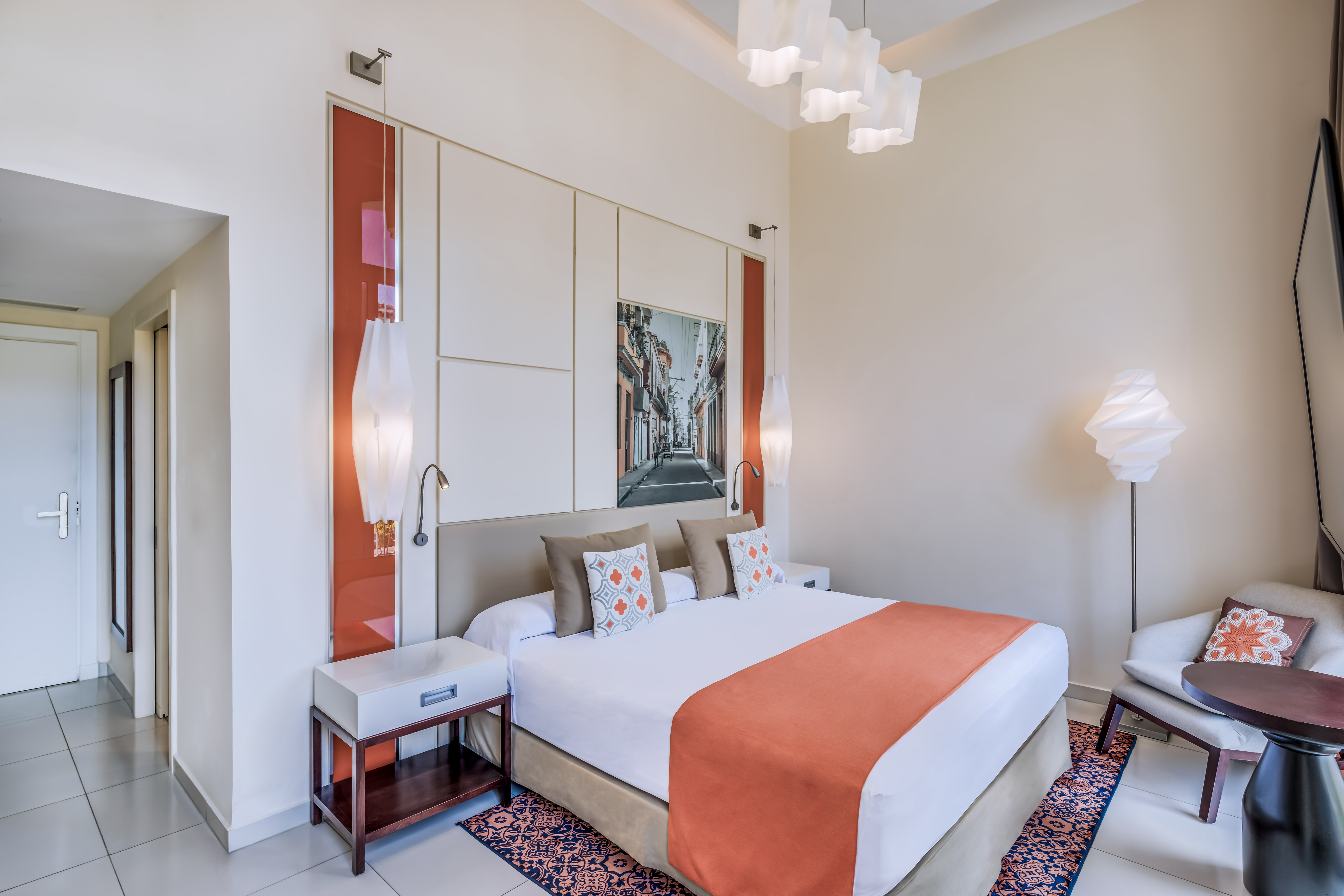 a bedroom with a bed and lamps