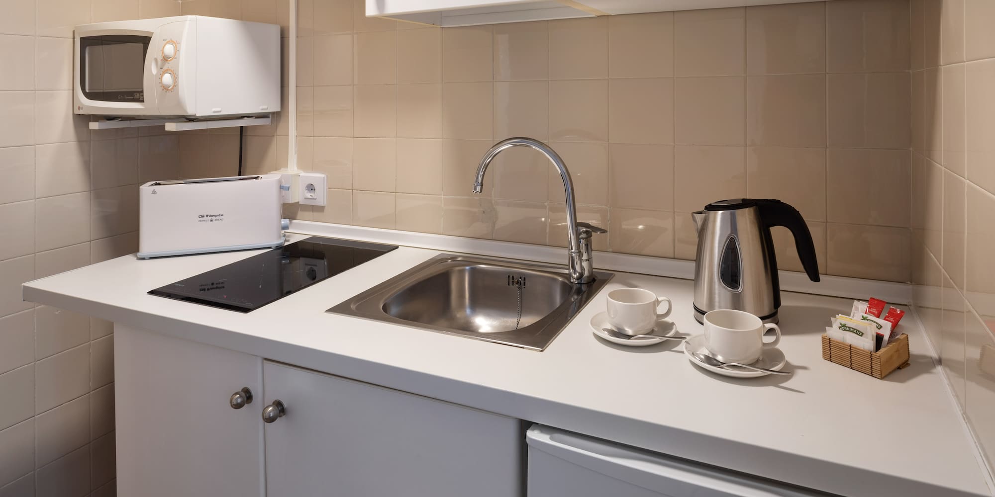 a kitchen with a sink and a kettle