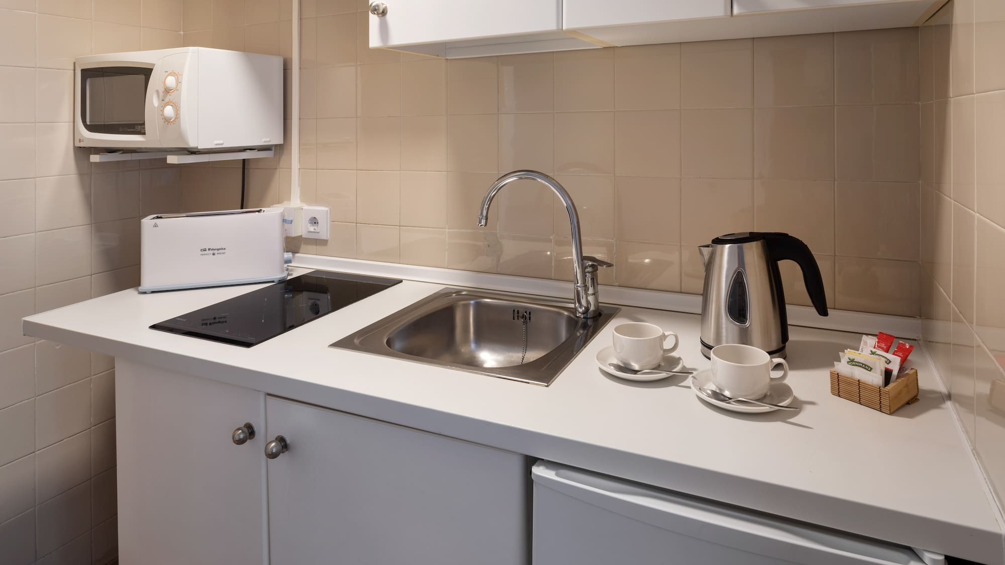a kitchen with a sink and a kettle