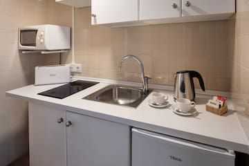 a kitchen with a sink and a kettle