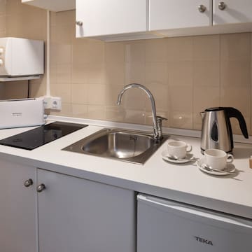 a kitchen with a sink and a kettle