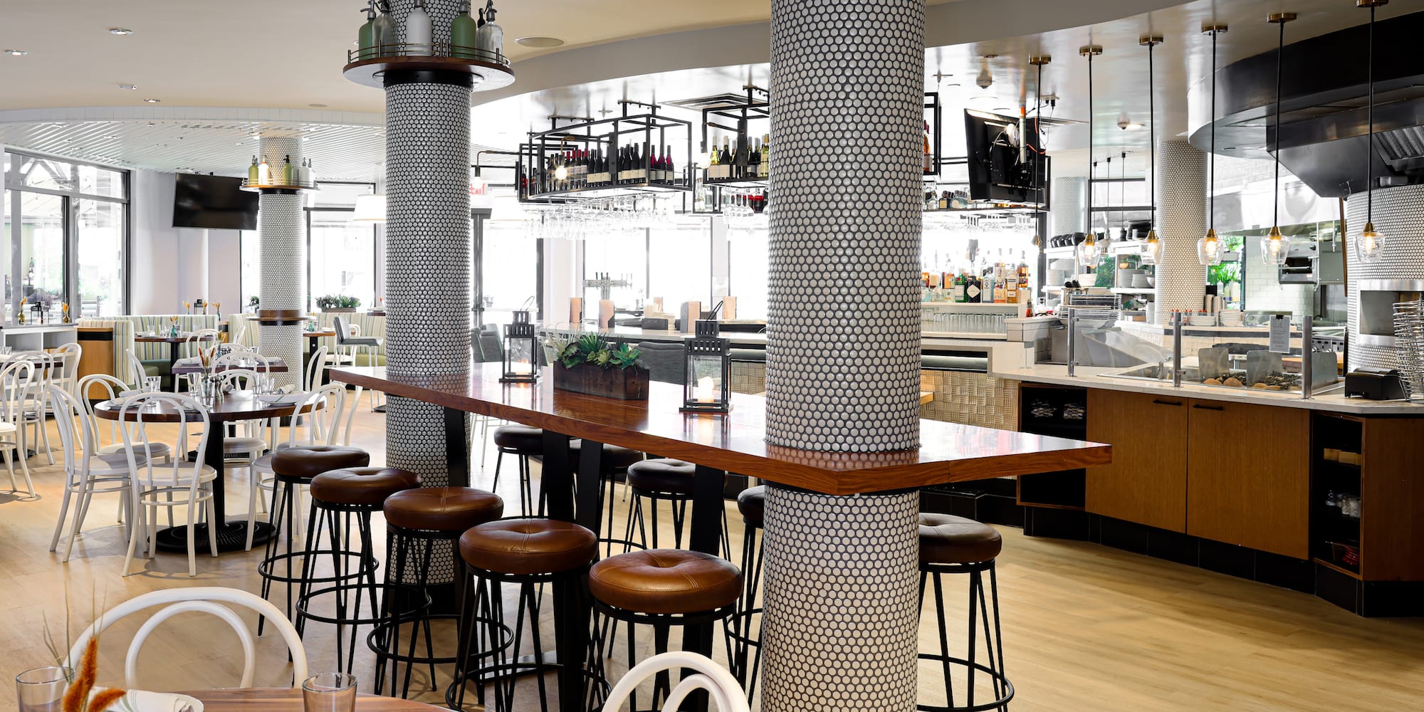 a bar with stools and tables in a restaurant