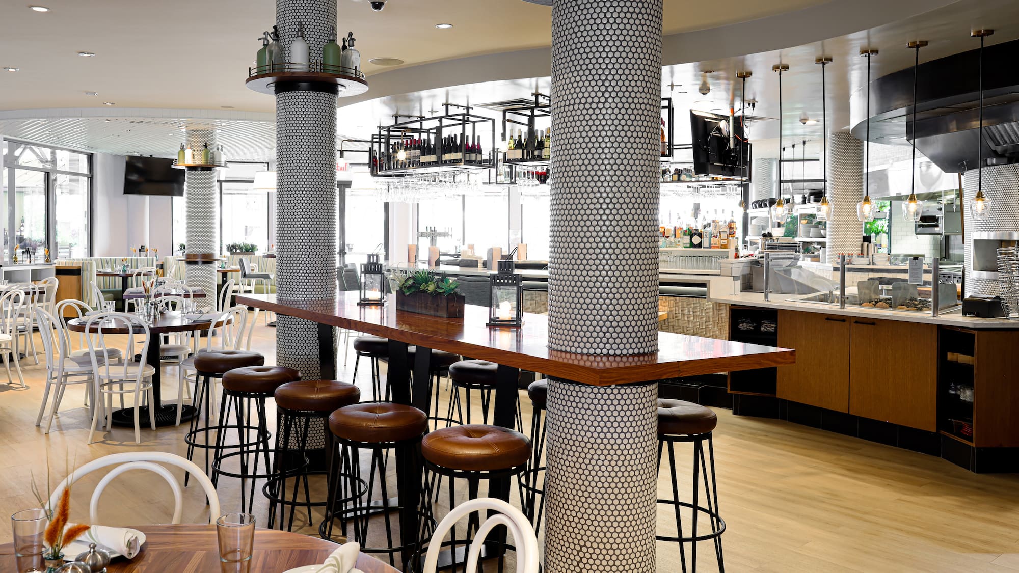 a bar with stools and tables in a restaurant