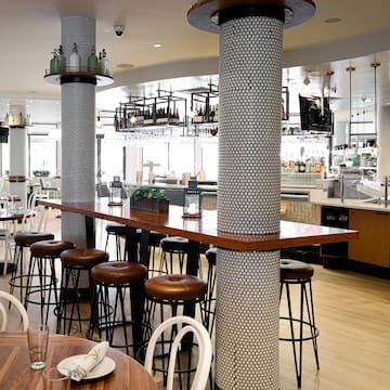 a bar with stools and tables in a restaurant