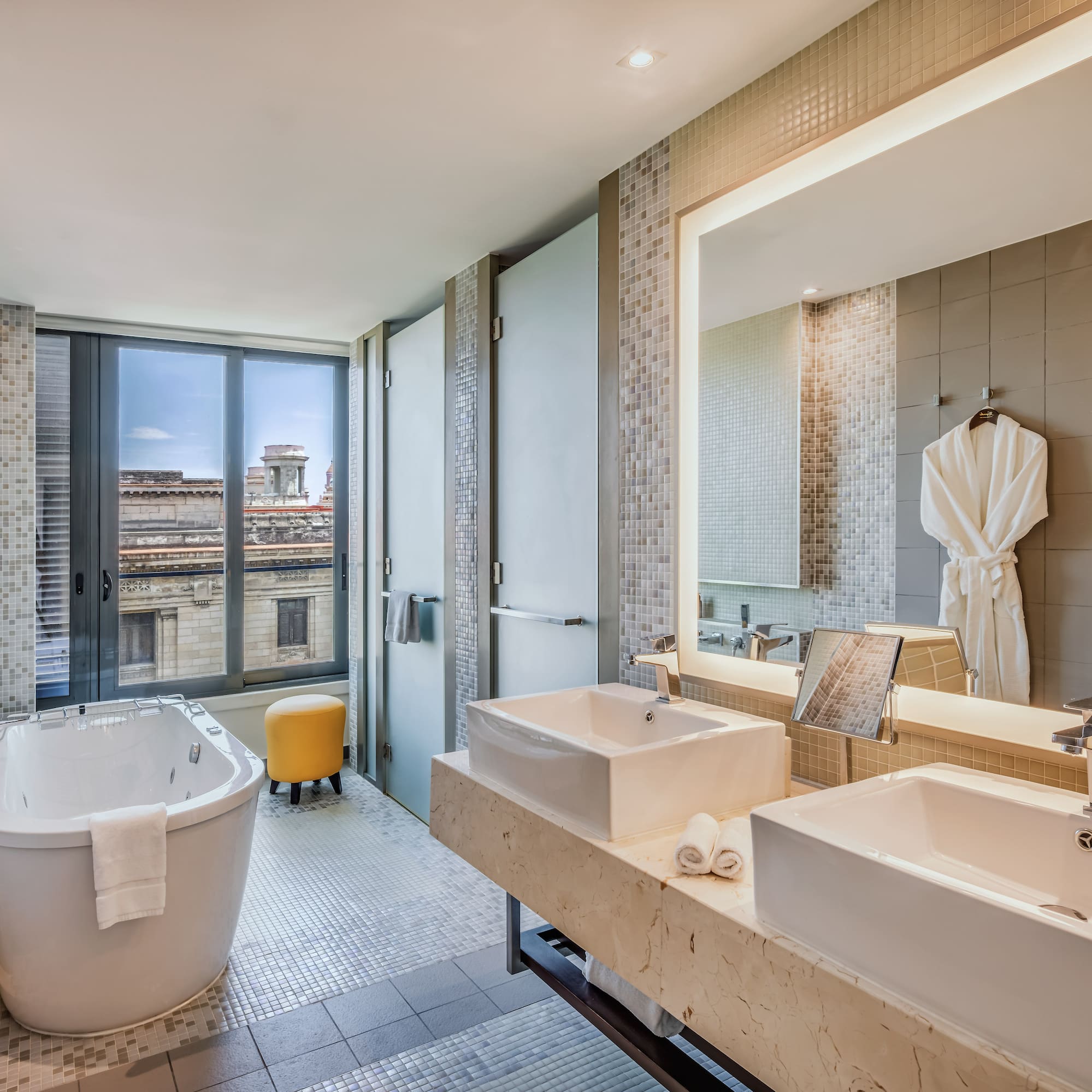 a bathroom with a tub and sinks