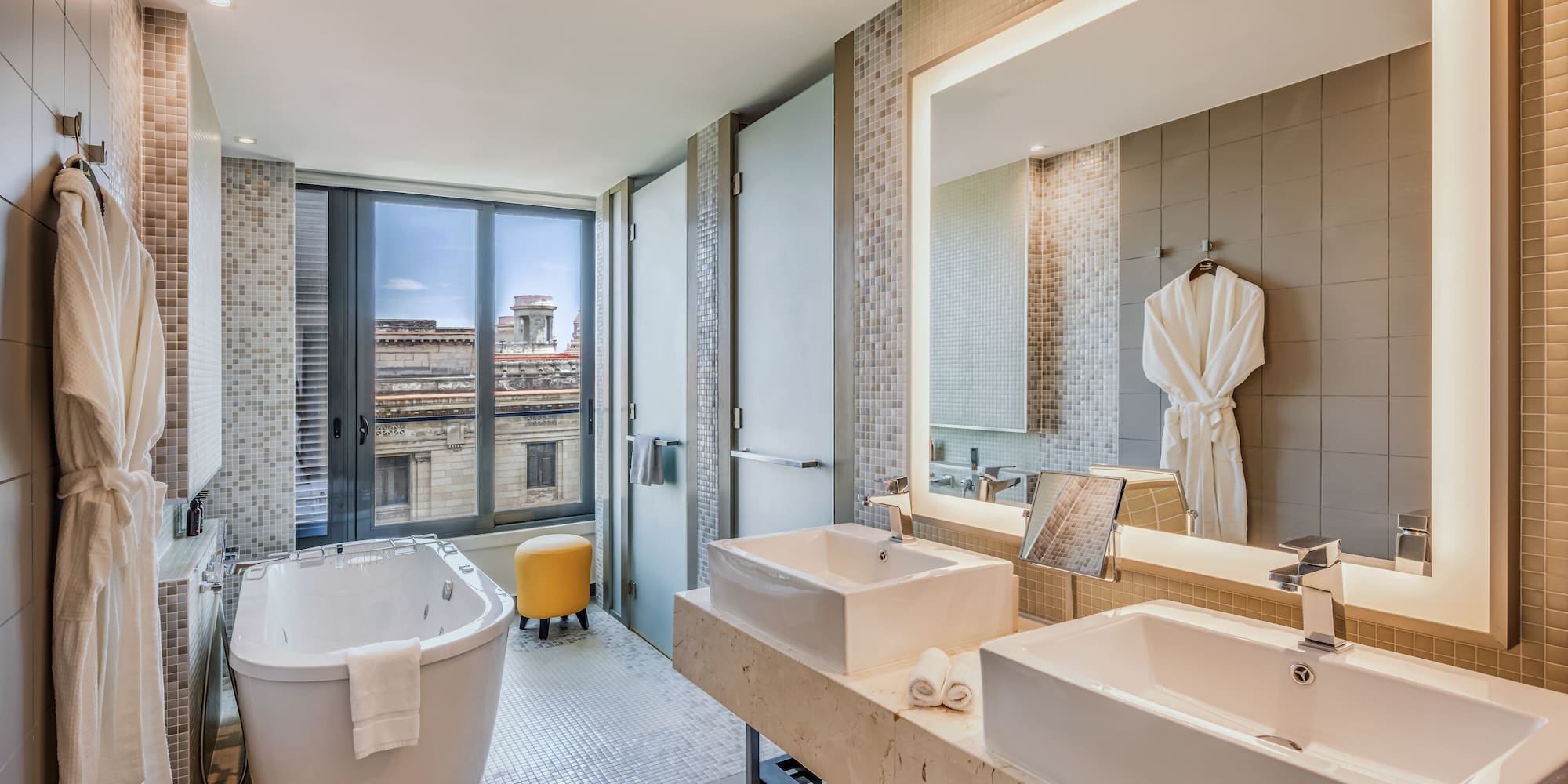 a bathroom with a tub and sinks