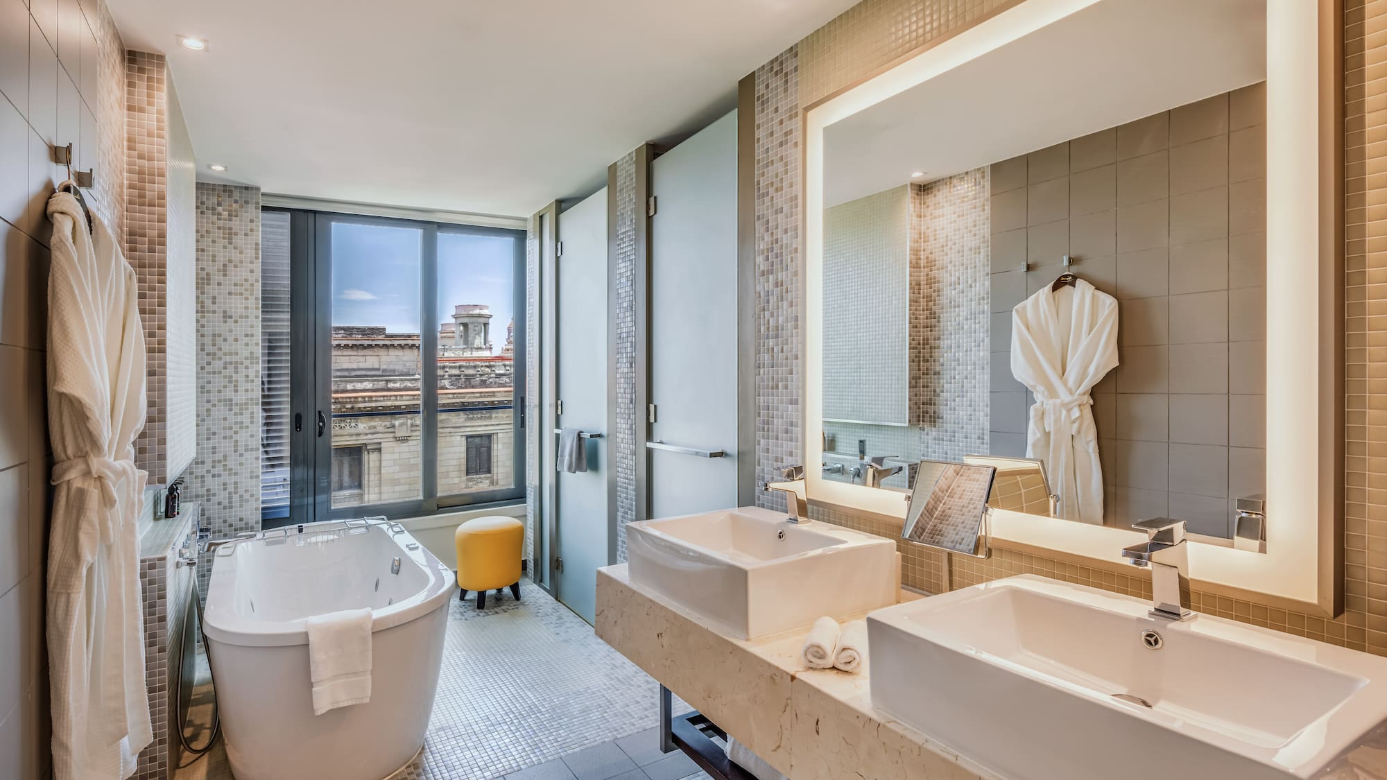 a bathroom with a tub and sinks