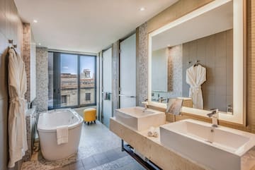 a bathroom with a tub and sinks