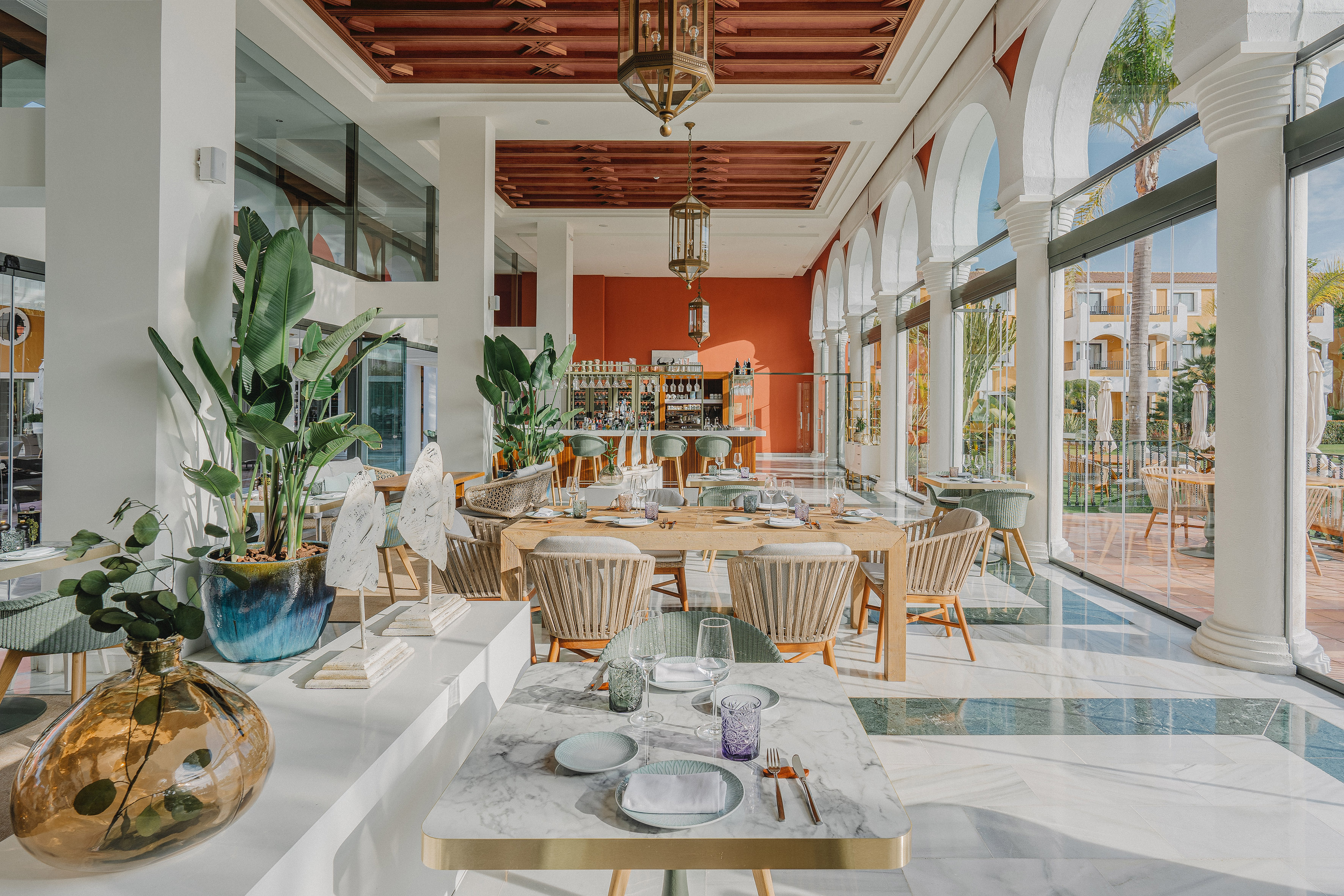 Bright Mediterranean restaurant with elegant dining, bar, and outdoor views.