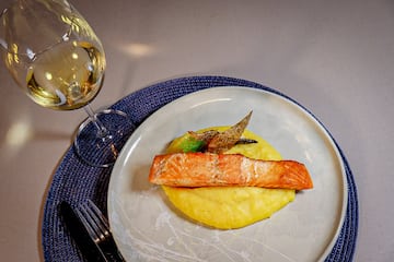 a plate of food and a glass of wine