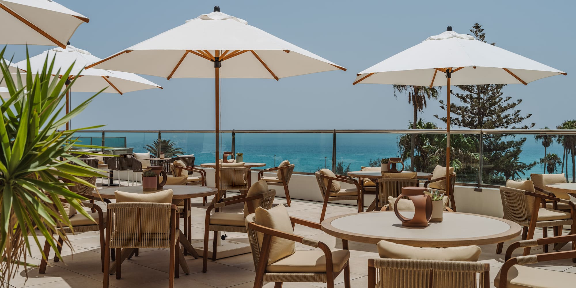 a patio with chairs and umbrellas