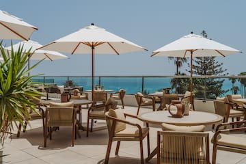 a patio with chairs and umbrellas