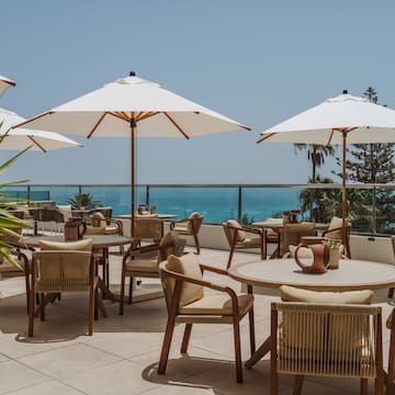a patio with chairs and umbrellas