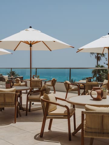 a patio with chairs and umbrellas