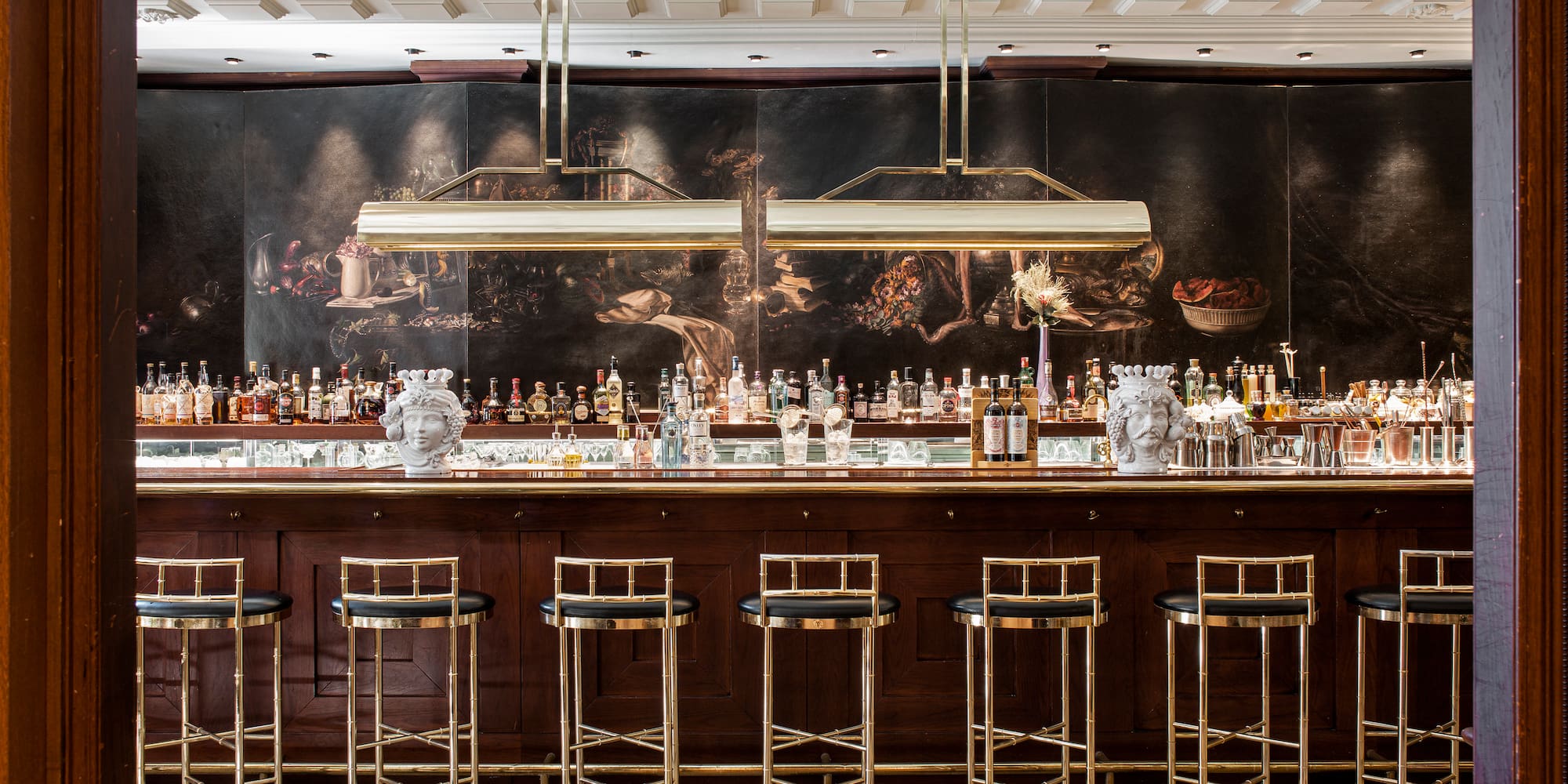 a bar with many bottles and stools