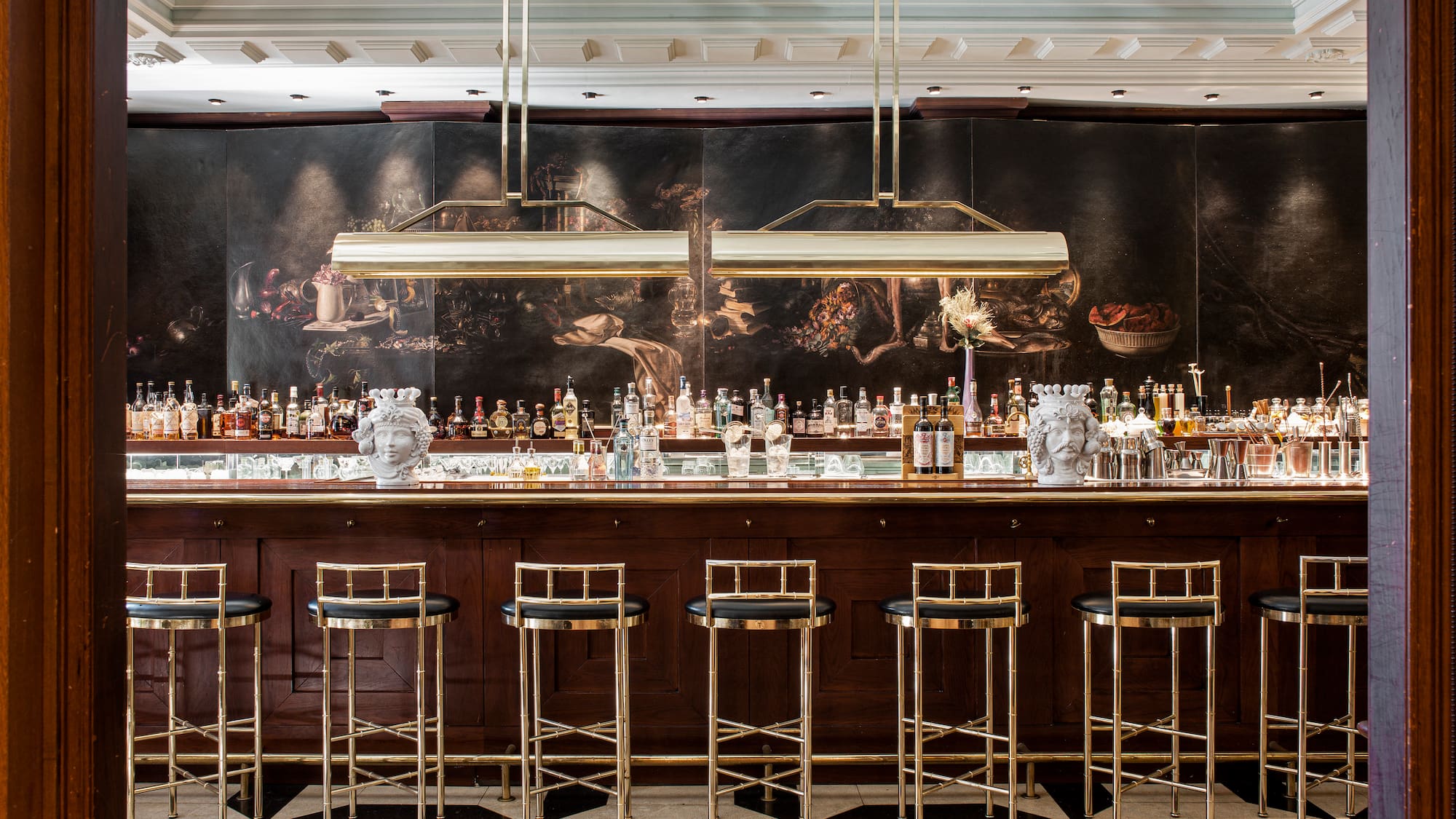 a bar with many bottles and stools