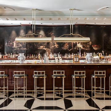 a bar with many bottles and stools