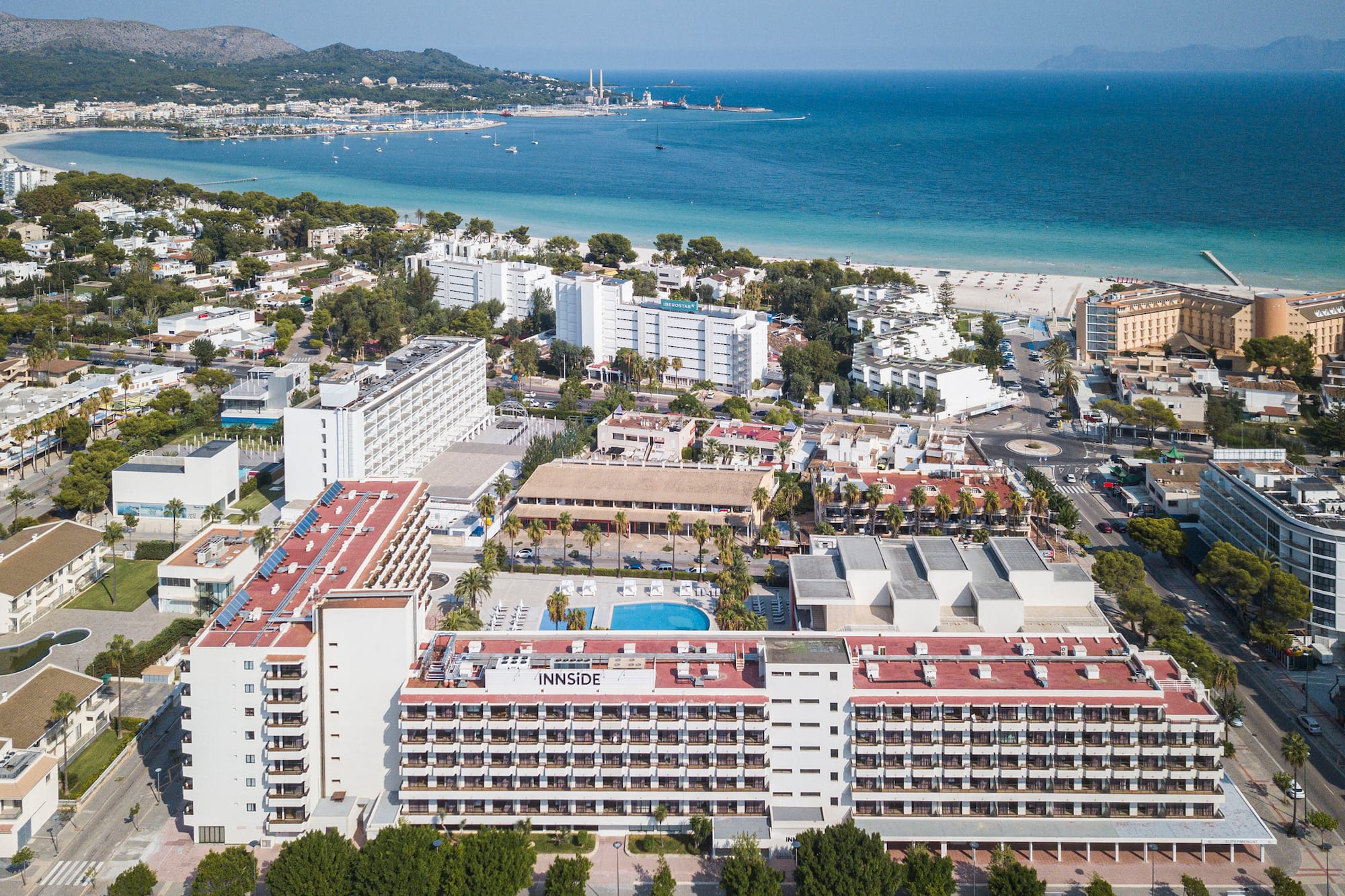 a large white building next to a beach