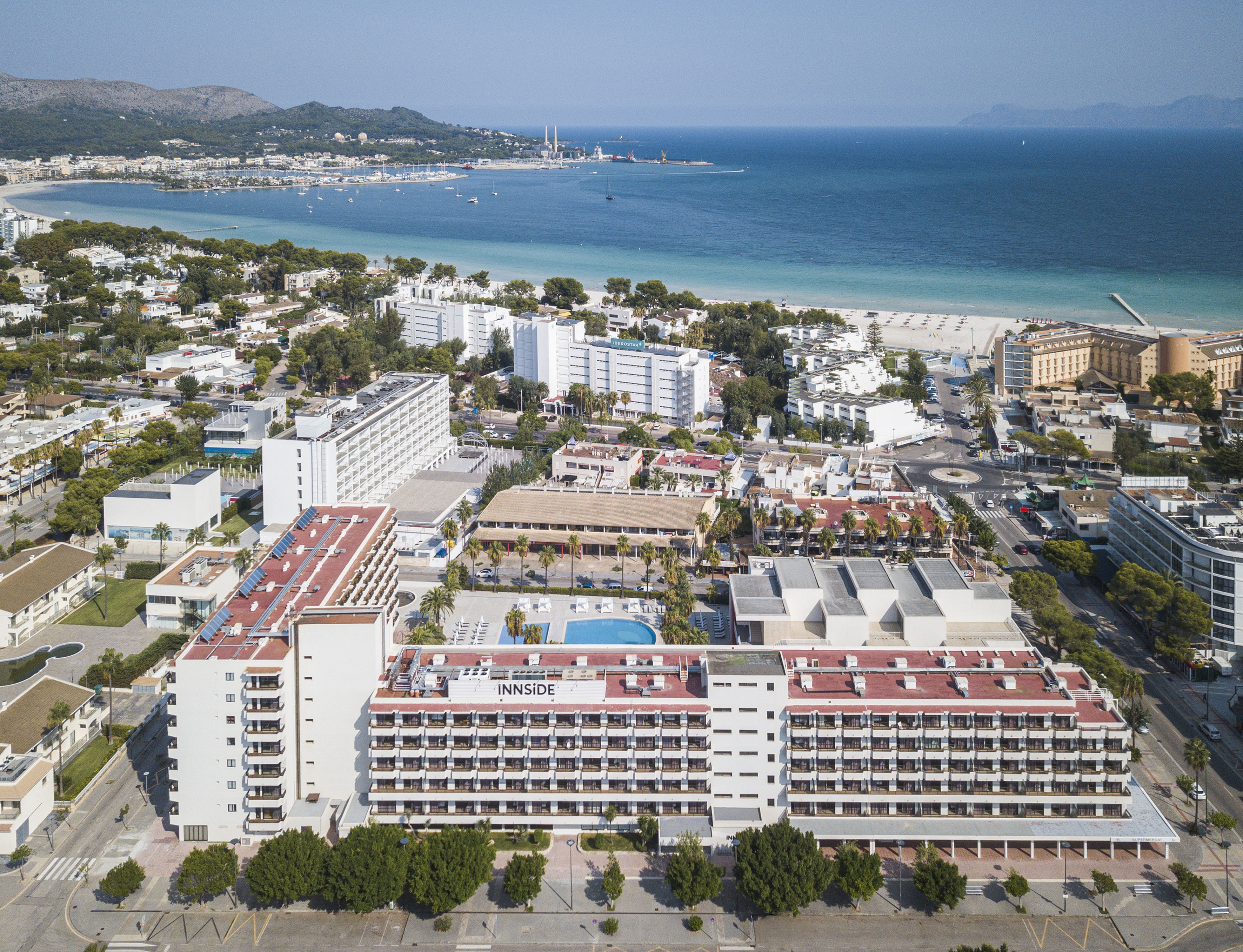 a large white building next to a beach