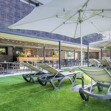 a patio area with chairs and umbrellas