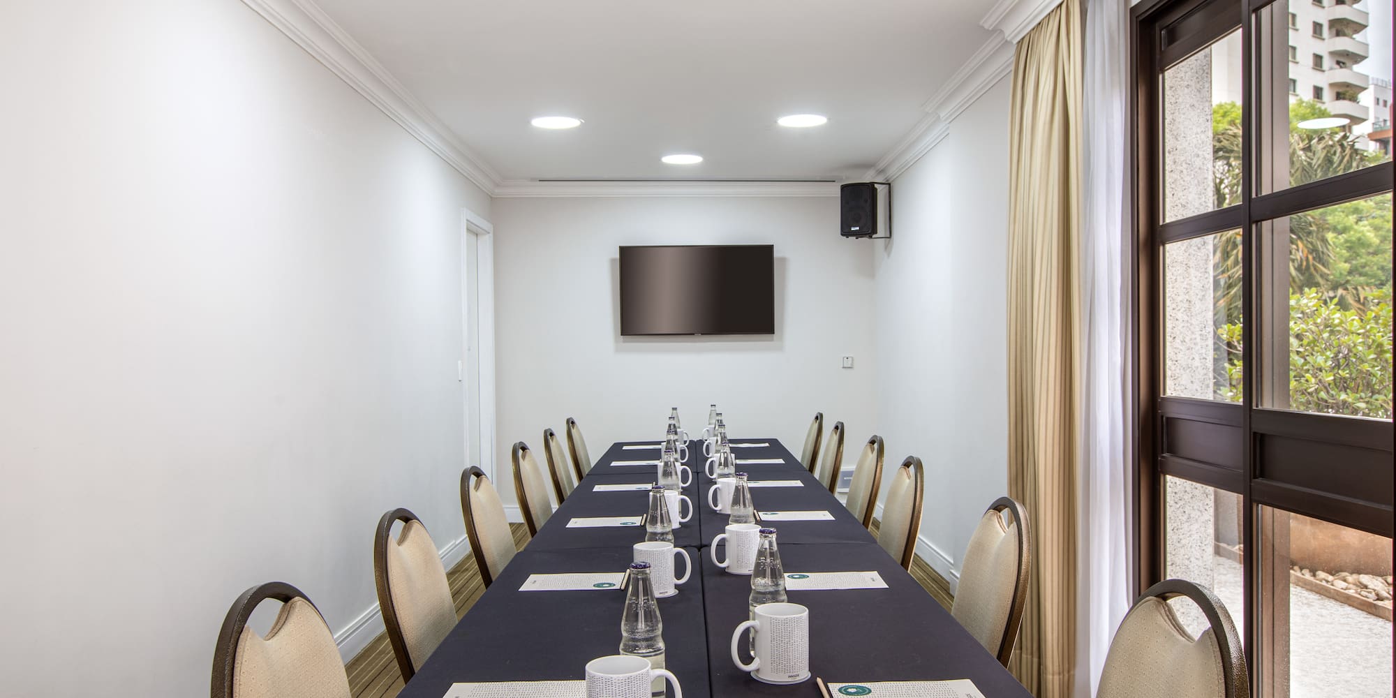 a long table with cups and papers on it