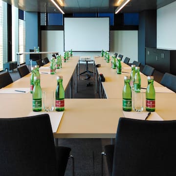 a conference room with empty tables and chairs
