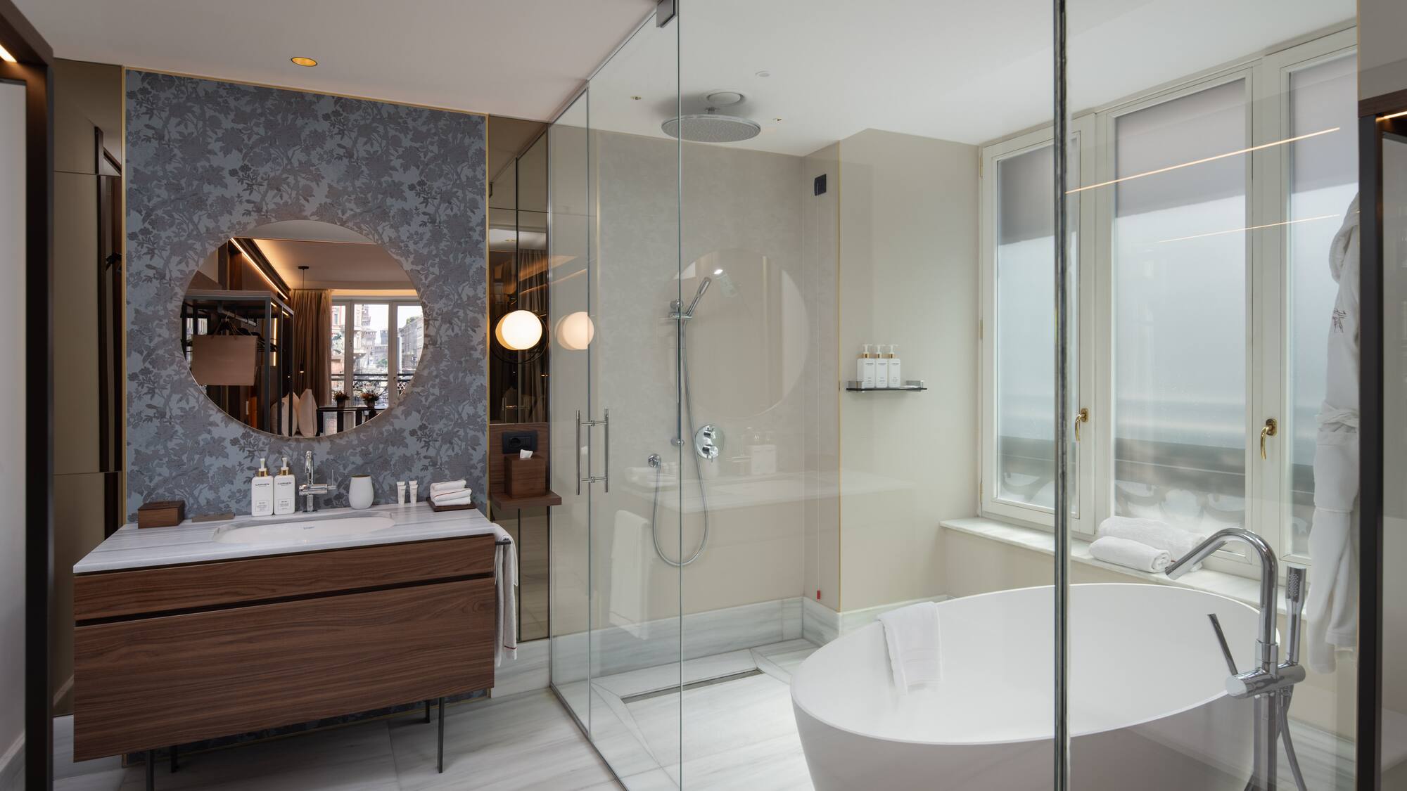 Luxury hotel bathroom with modern design, freestanding tub, glass shower, marble vanity.