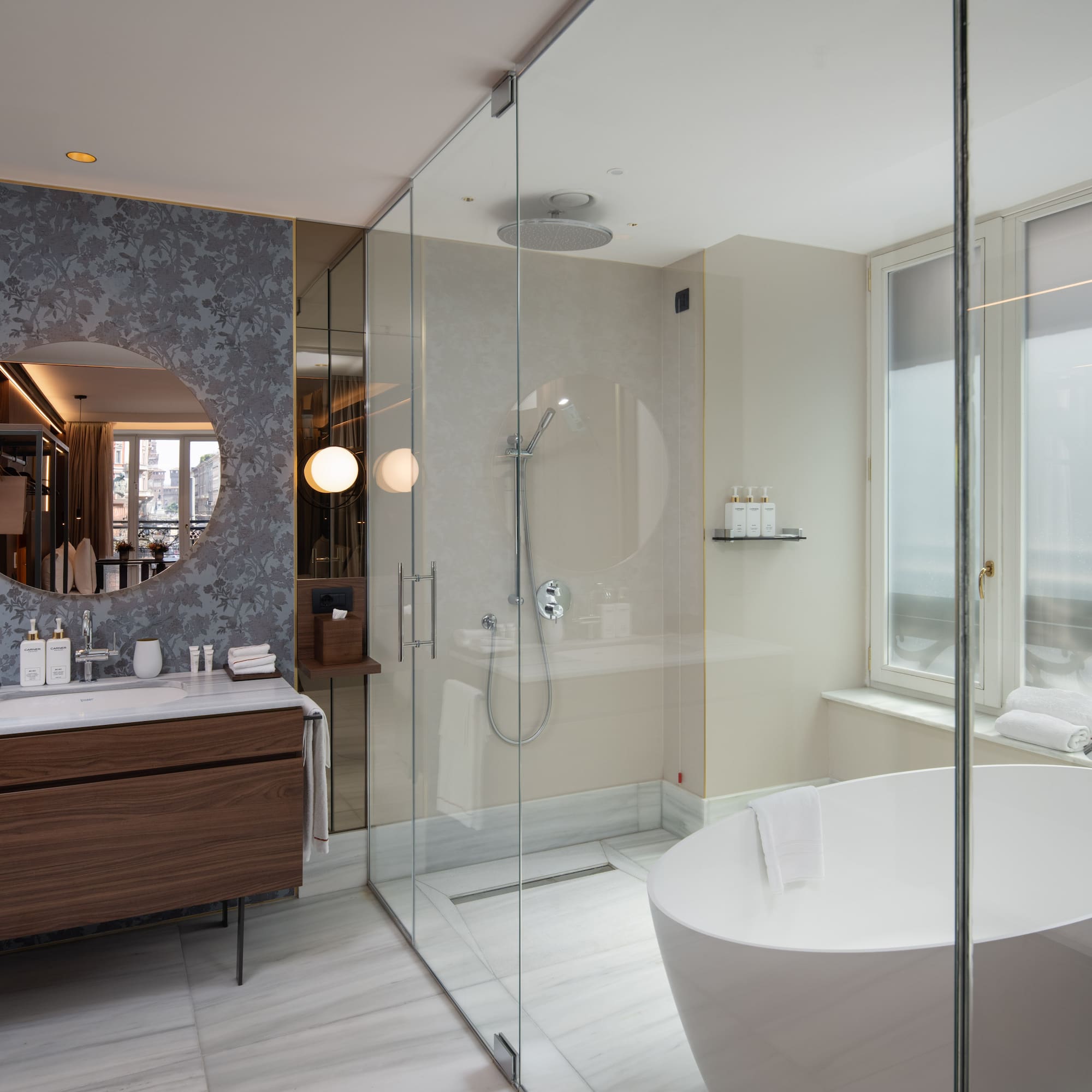 Luxury hotel bathroom with modern design, freestanding tub, glass shower, marble vanity.