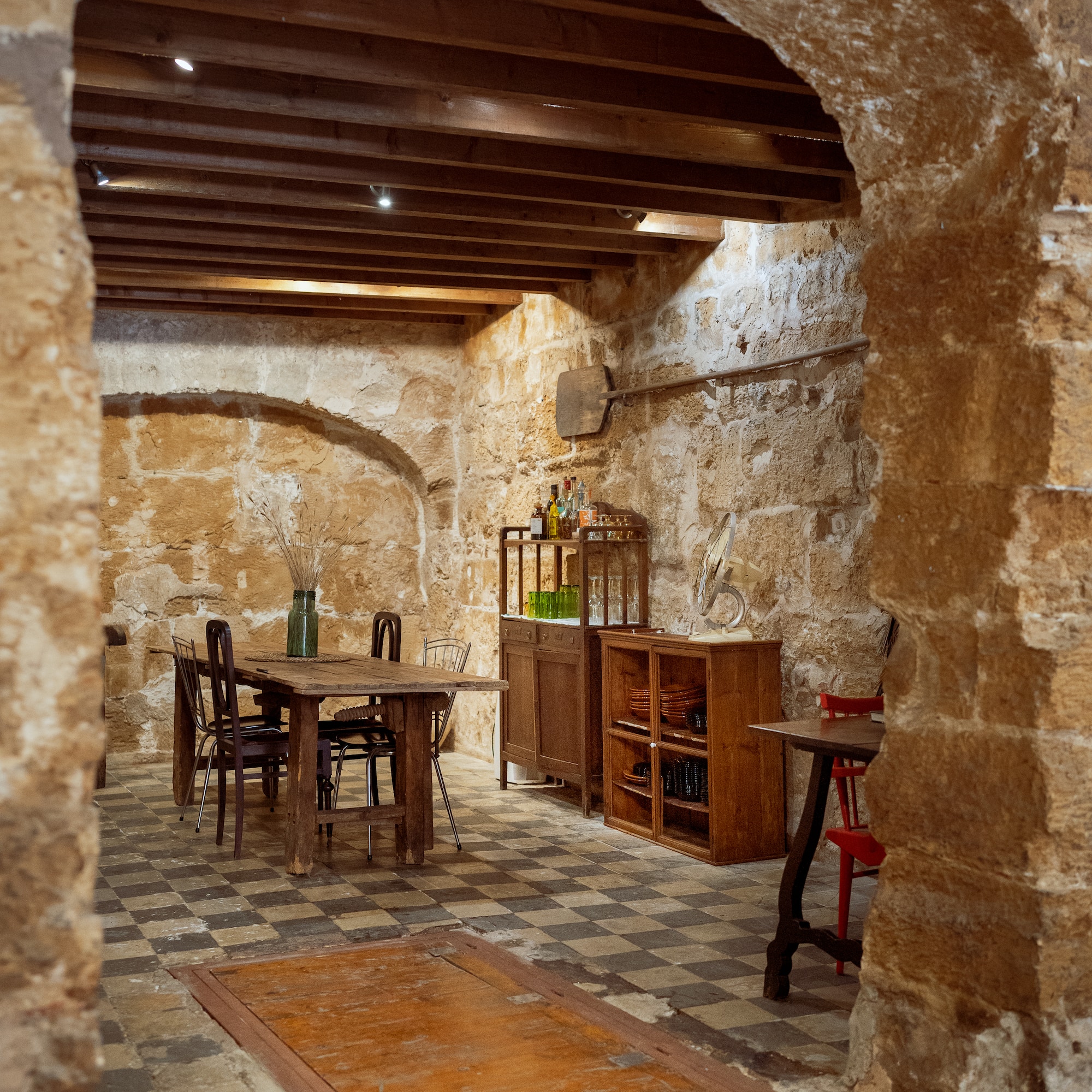 a stone room with a table and chairs