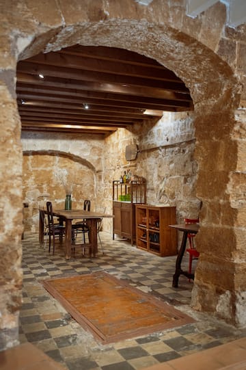 a stone room with a table and chairs