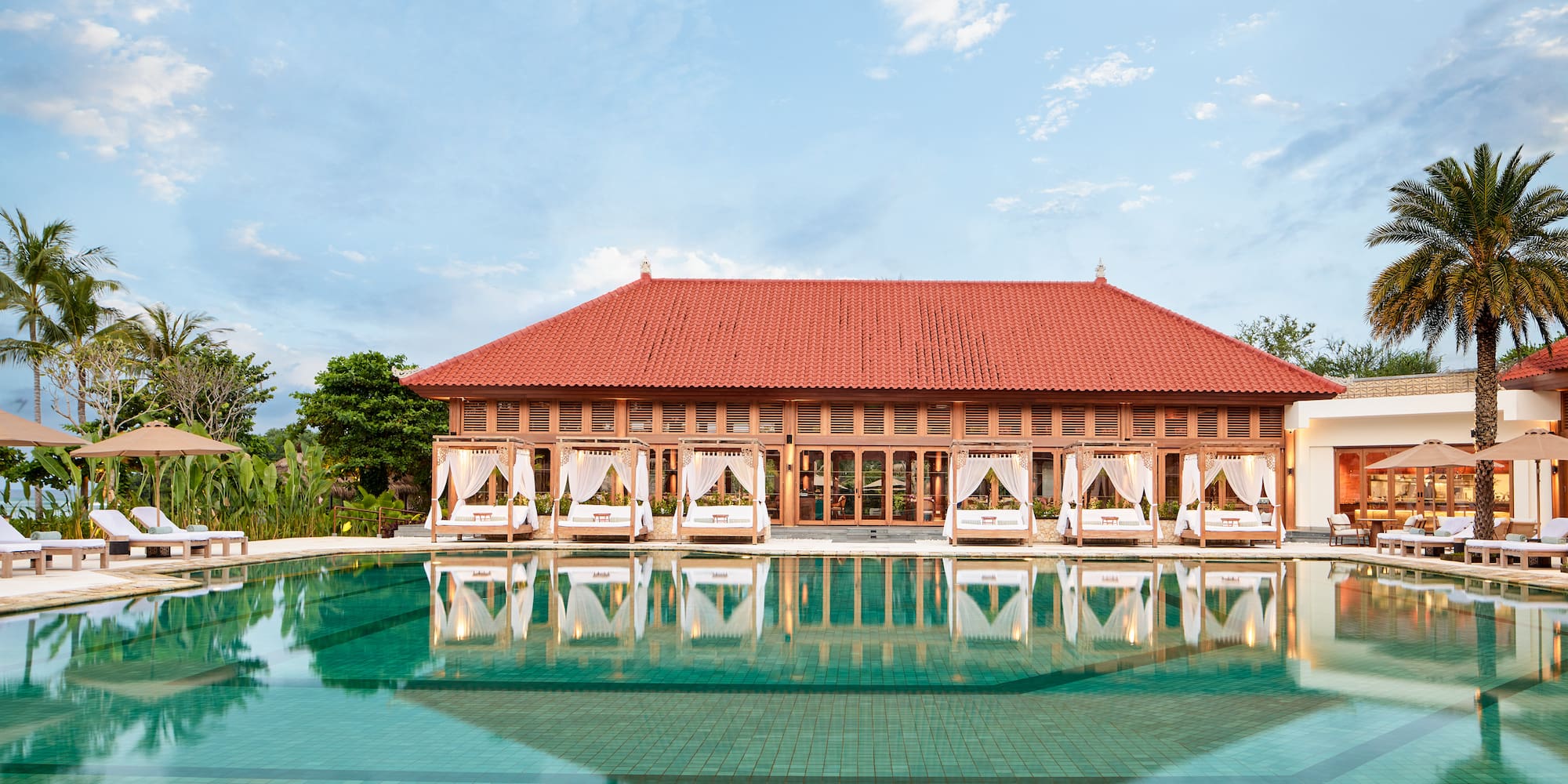 a pool with a building and a gazebo