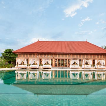 a pool with a building and a gazebo