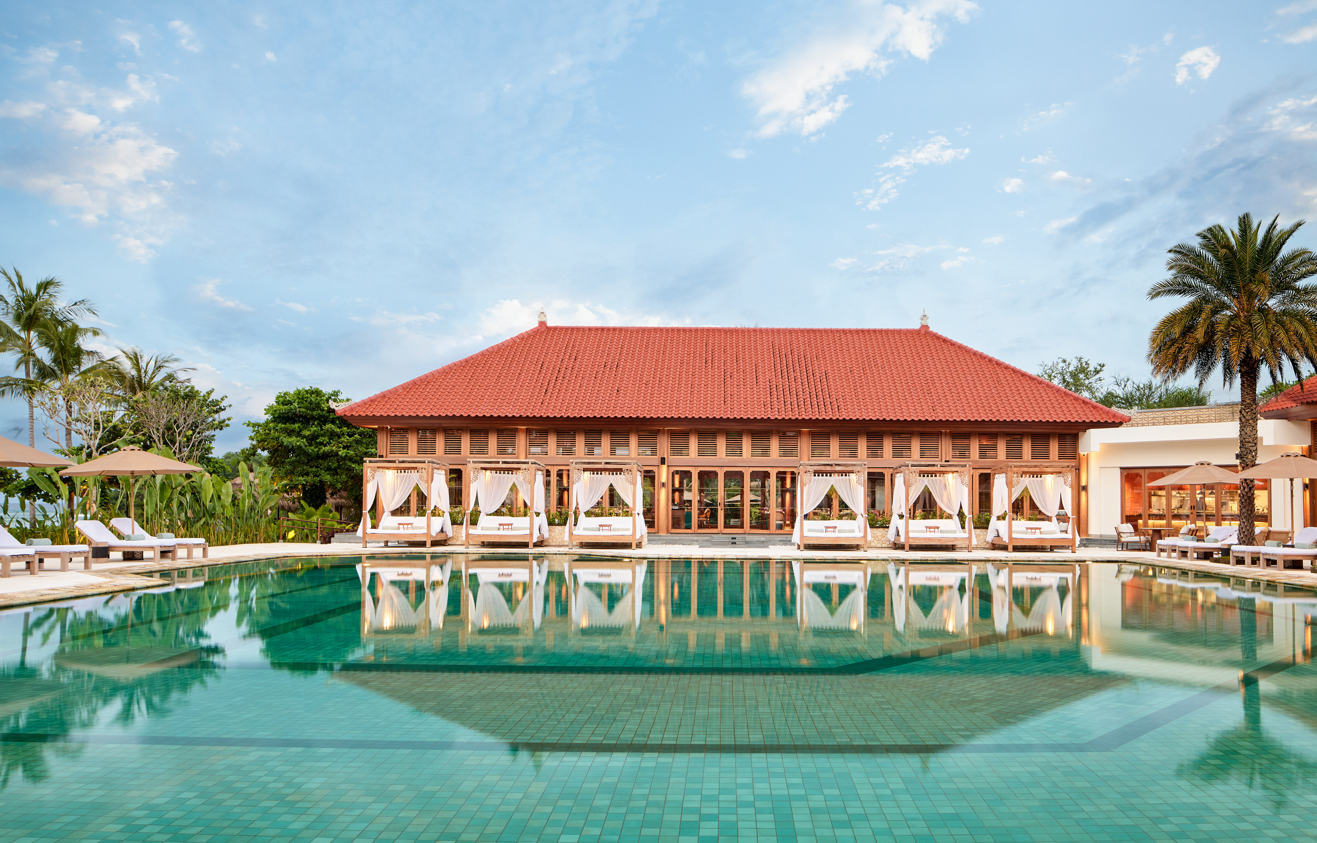a pool with a building and a gazebo