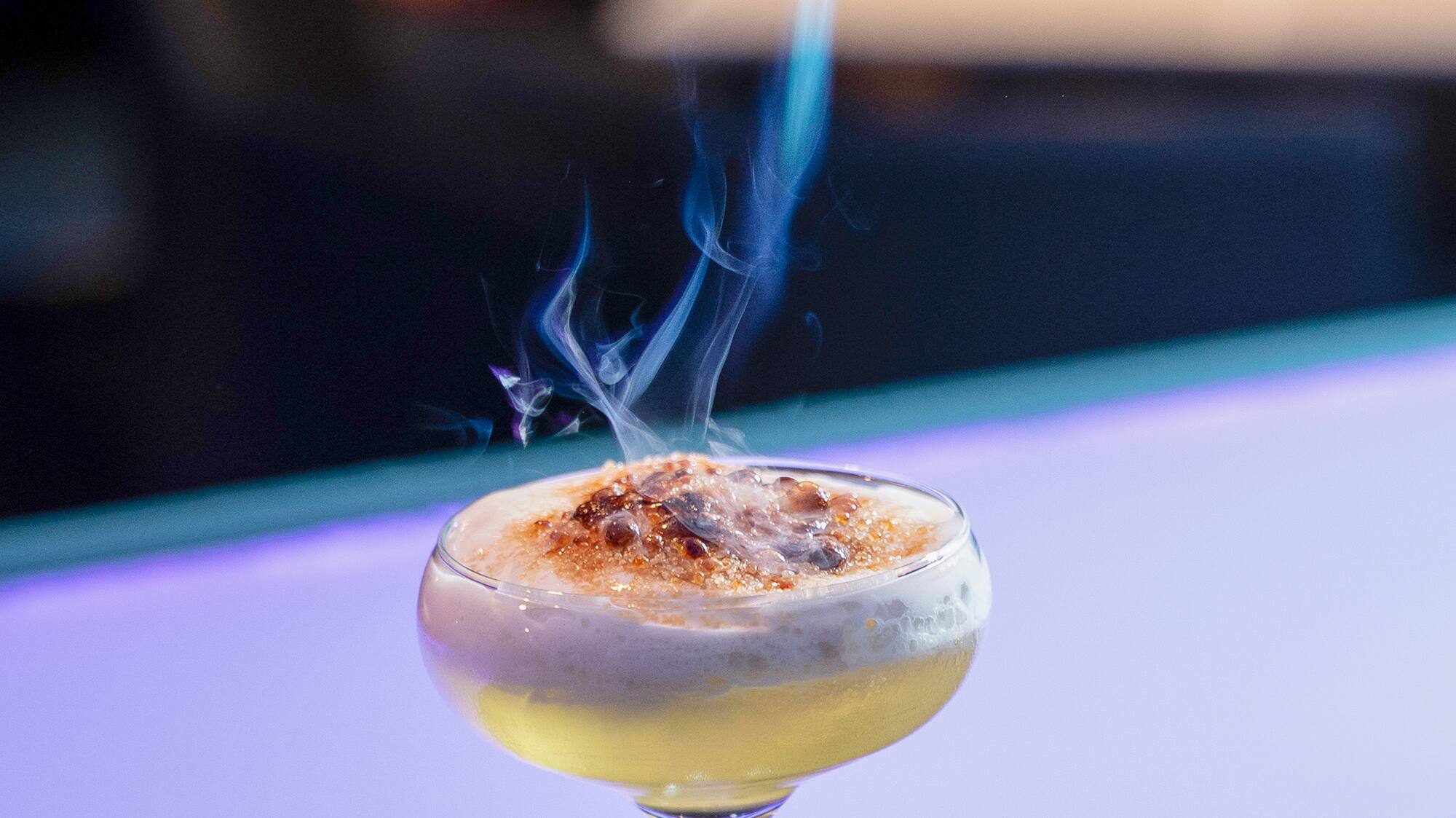 a fire coming out of a drink